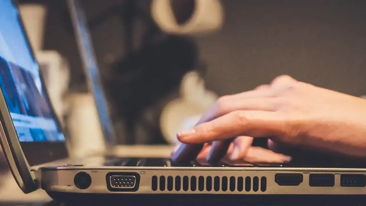 a person typing on a laptop